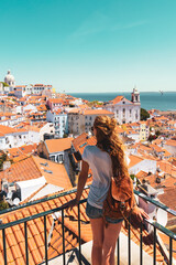 Traveler Woman, tourist on balcony looking at panoramic view of Lisboa- Tourism, vacation, travel in Portugal