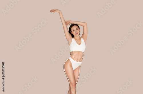 Sexy millennial woman in underwear with contouring mark on body