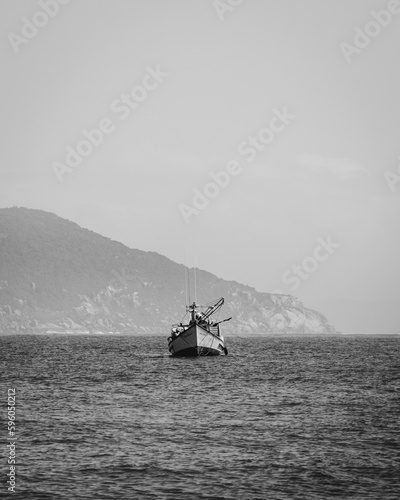 fishing boat near the shore black and white