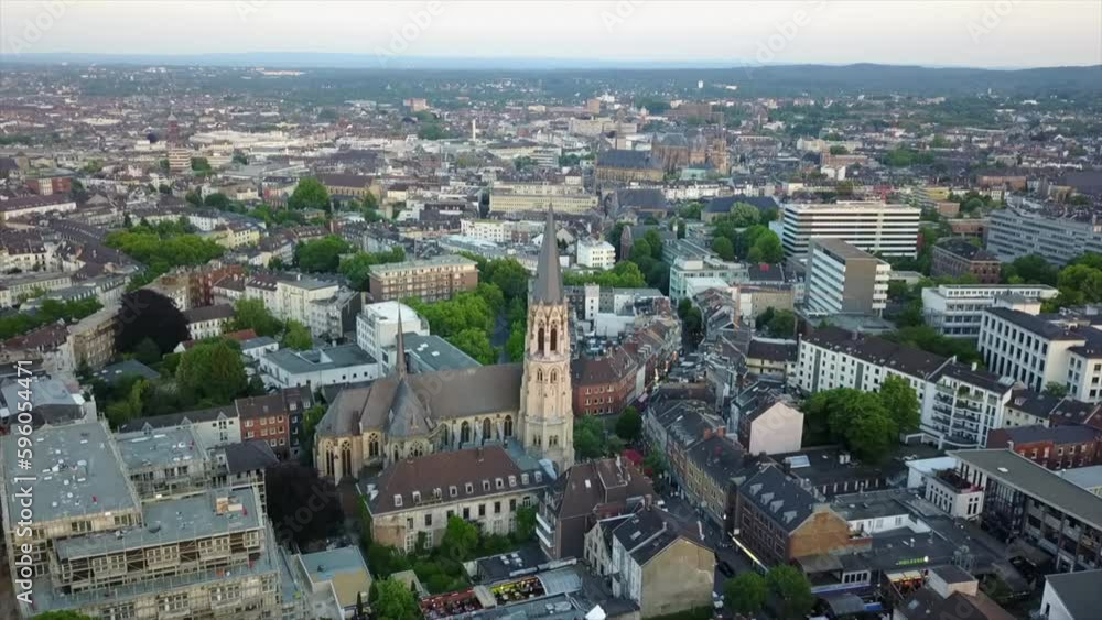 Forwards fly above town around church tower. Panoramic view of urban borough. Heilig Kreuz Kirche in Aachen, Germany Forwards fly above town around church tower. Panoramic view of urban borough. Heilig Kreuz Kirche in Aachen, Germany