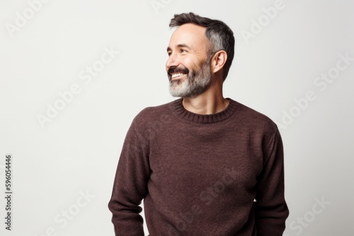 Portrait of a middle-aged man in a brown sweater on a white background