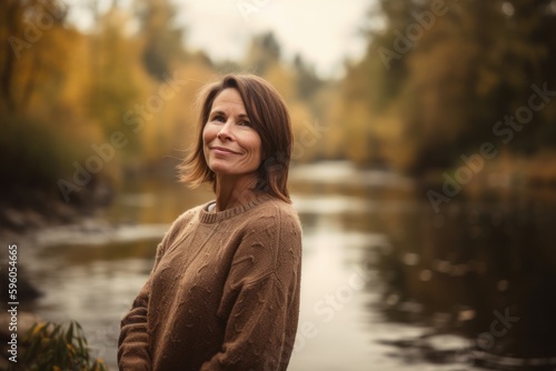 Portrait of a middle-aged woman on the background of autumn forest