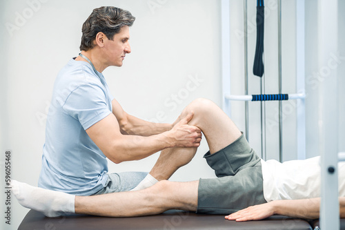 Confident doctor working with the patient in rehabilitation center