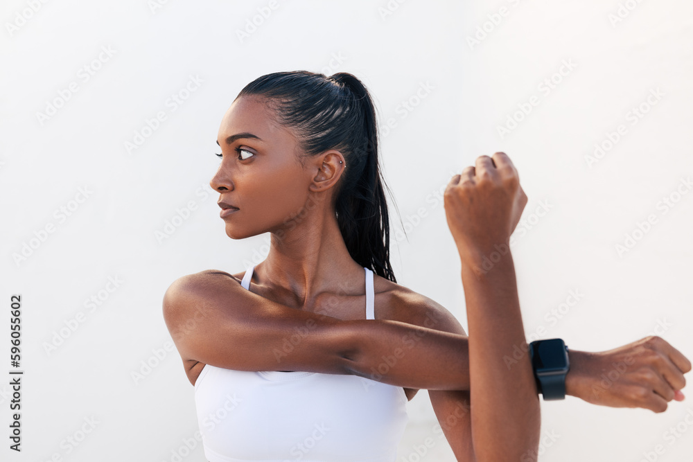 Young woman flexing her hands and looking away. Female stretching and warming up her hands before a workout. Young woman flexing her hands and looking away. Female stretching and warming up her hands before a workout.
