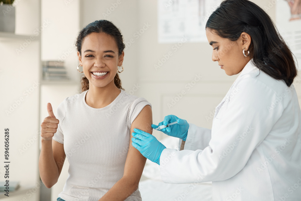 This isnt as bad as it looks. an attractive young doctor standing and injecting her patient during a consultation in the clinic. This isnt as bad as it looks. an attractive young doctor standing and injecting her patient during a consultation in the clinic.