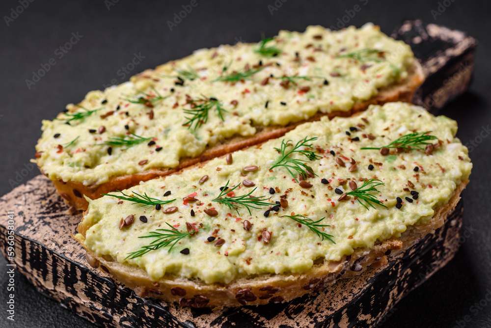 Grilled toast with avocado paste, eggs, cream cheese, salt, spices and herbs Grilled toast with avocado paste, eggs, cream cheese, salt, spices and herbs