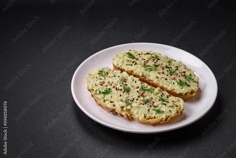 Grilled toast with avocado paste, eggs, cream cheese, salt, spices and herbs Grilled toast with avocado paste, eggs, cream cheese, salt, spices and herbs