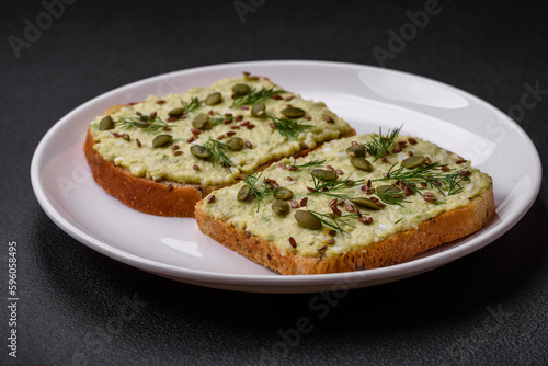 Grilled toast with avocado paste, eggs, cream cheese, salt, spices and herbs