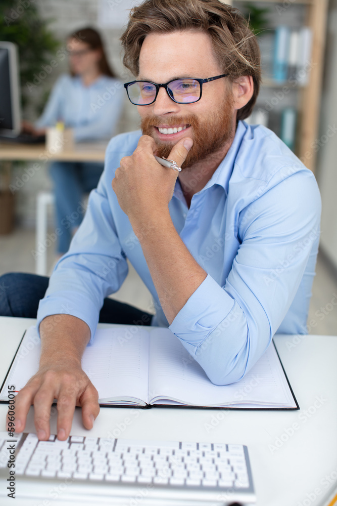 Fototapeta premium portrait of happy man at his desk in office