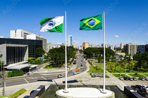 Flags of Paraná (left side), state located in the southern region of Brazil - flag on the right side, and in the background on the left side the Legislative Assembly of Paraná (Alep).