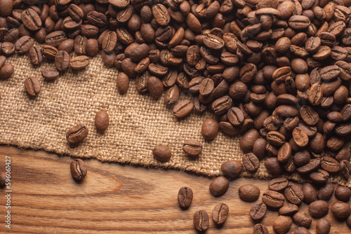 Coffee beans on sackcloth on wooden table