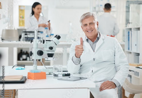 Its all good here. Portrait of a senior scientist showing thumbs up while working in a lab.