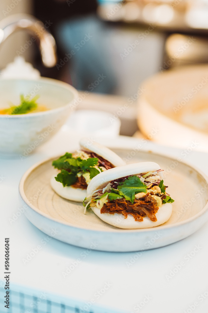 Vertical view of the appetizer serving on white plate at expensive restaurant background