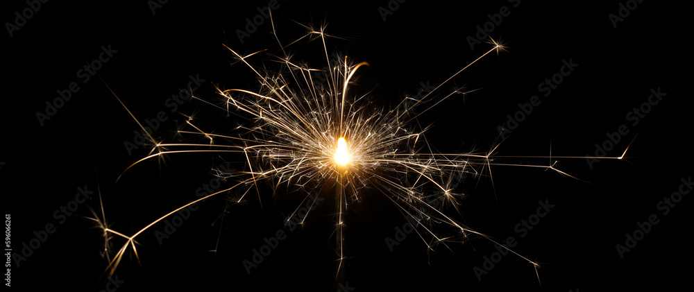 A burning sparkler with black background