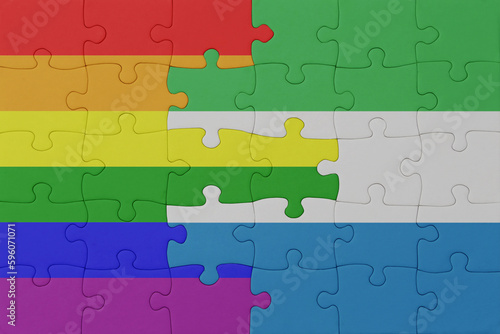 puzzle with the flag of rainbow gay pride and sierra leone . macro.concept.