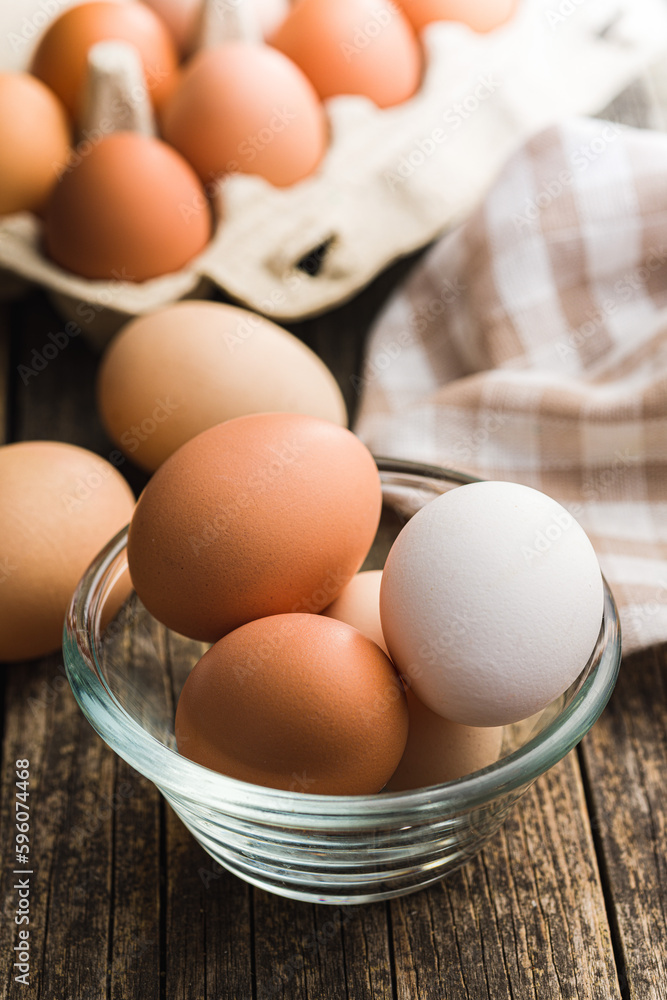 Whole chicken eggs in bowl on wooden table. Whole chicken eggs in bowl on wooden table.