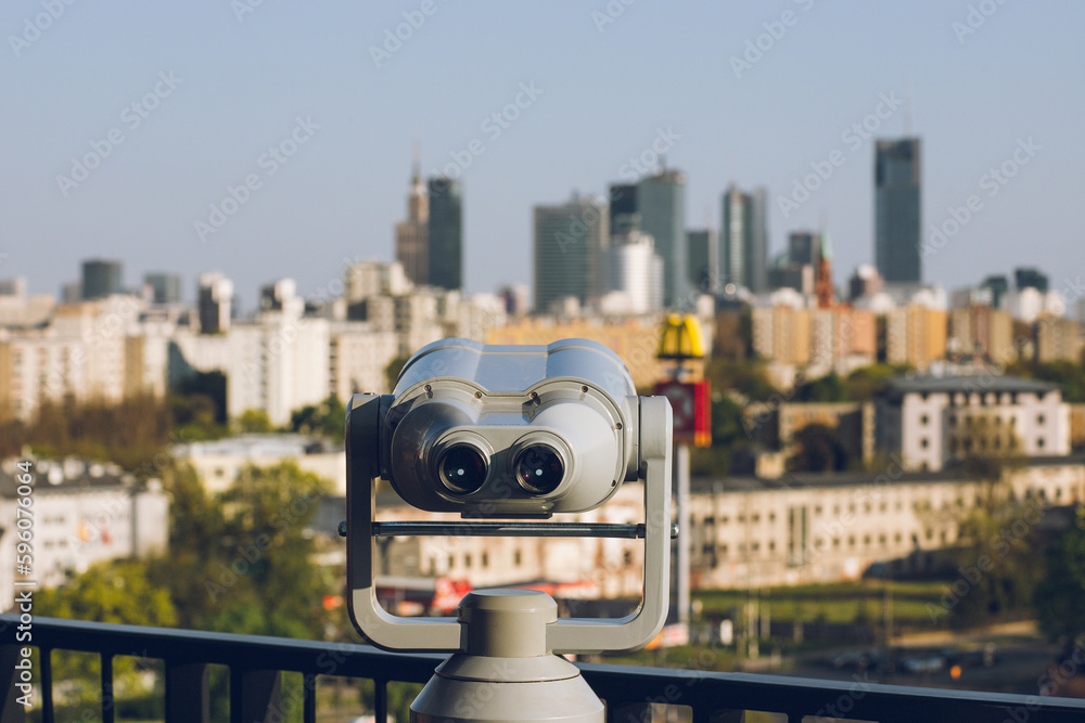 Observation deck with binoculars and a view of a modern business center with office buildings:Warsaw/Poland-22 April 2023