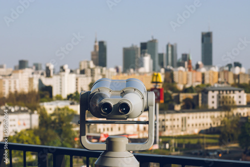 Observation deck with binoculars and a view of a modern business center with office buildings:Warsaw/Poland-22 April 2023