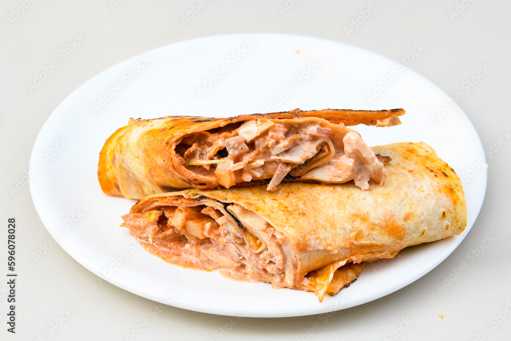 Lavash doner kebab ( zurna doner durum ) or shawarma sliced in plate isolated. Lavash doner kebab ( zurna doner durum ) or shawarma sliced in plate isolated.