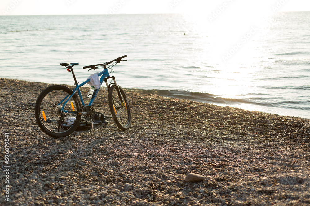 Fototapeta premium bike on the beach at dawn on the black sea