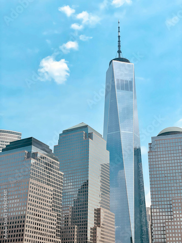 New York, NY, USA - June 2022: Freedom Tower building at One World Trade Center along with other buildings nearby.