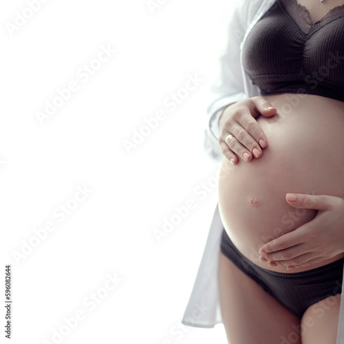 pregnant belly close-up, young woman in late pregnancy hugs her tummy, happy maternity leave