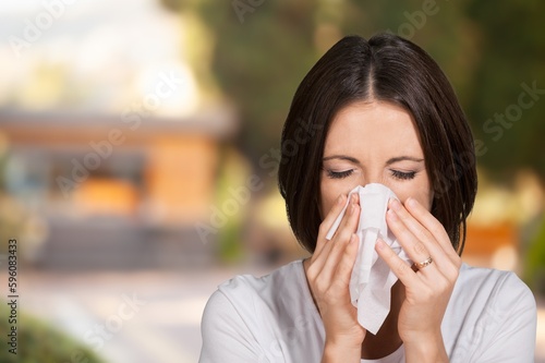 Sad young woman hold tissue sneeze