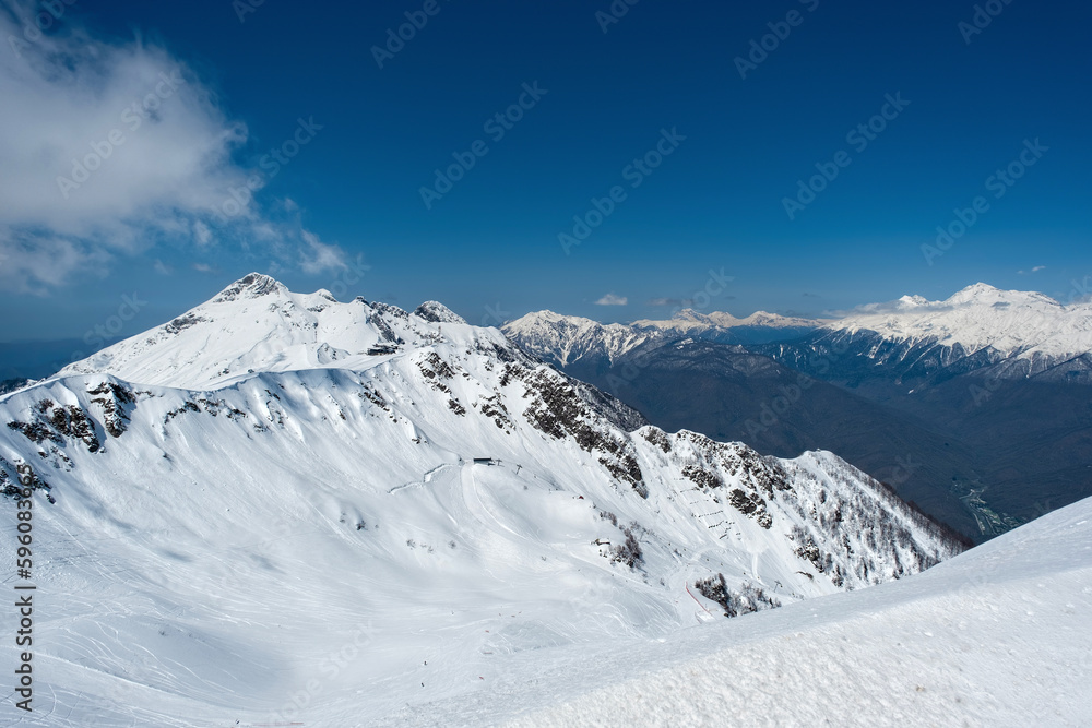 Beautiful snow capped peaks of the Caucasus Mountains. Rosa Khutor Alpine Resort in Sochi. Russia