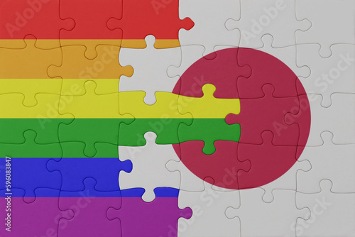 puzzle with the flag of rainbow gay pride and japan . macro.concept.