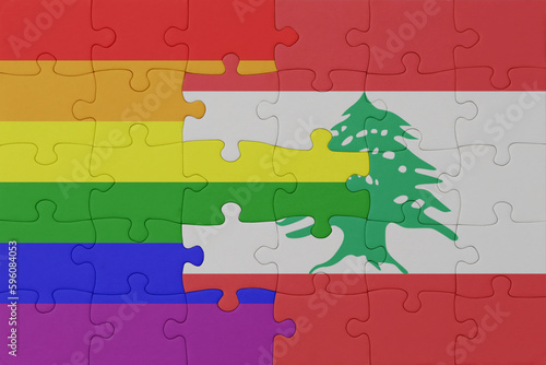 puzzle with the flag of rainbow gay pride and lebanon . macro.concept. photo