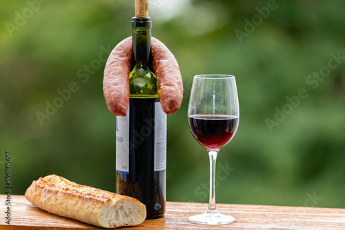 Red wine in a glass with bread and salami