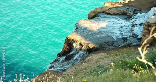 beautiful waterfall on the background of the evening sea