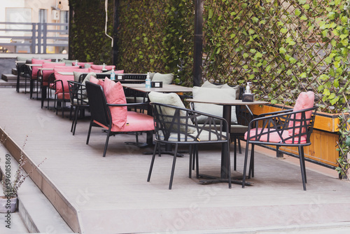 Cafe table and chairs on urban street - summer restaurant and coffee shop outdoor concept
