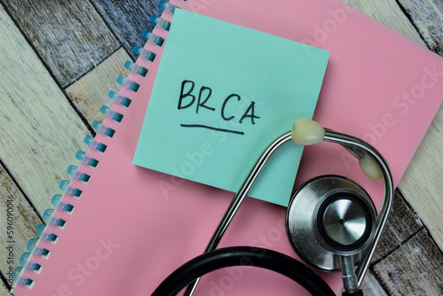 Concept of BRCA write on sticky notes isolated on Wooden Table. photo