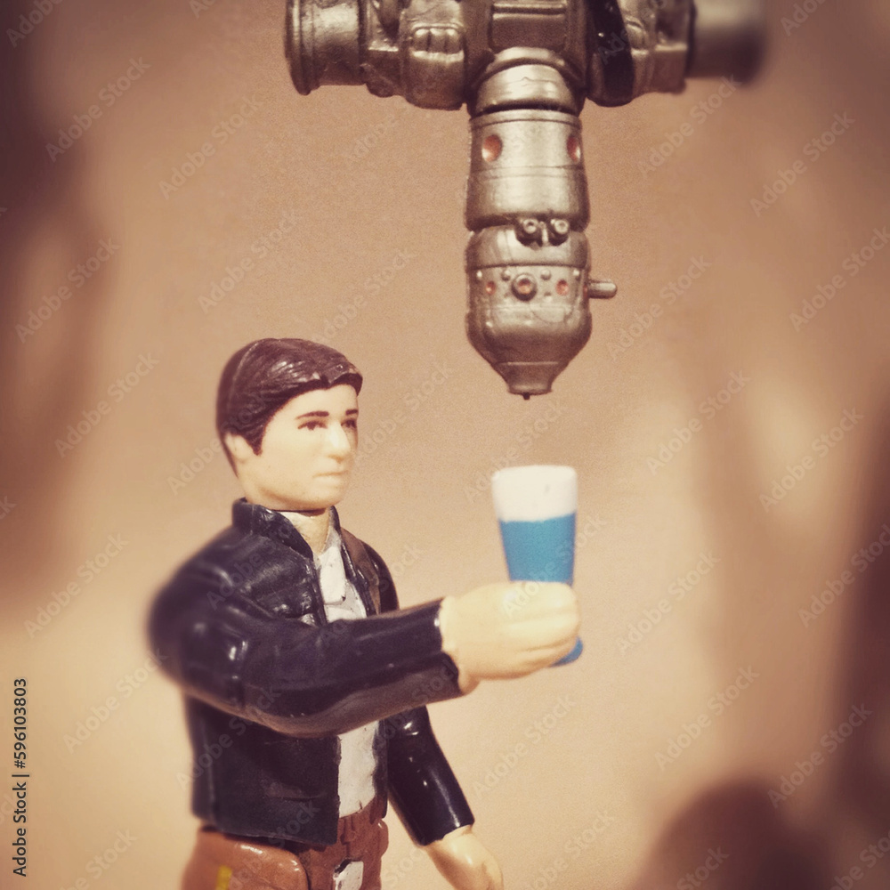 Fototapeta premium BLOOMFIELD, NEW JERSEY - MAY 14, 2015: Vintage Kenner Star Wars figure Han Solo and bounty hunter IG-88 - blue milk concept. IG-88's head was a recycled drink dispenser prop from the bar in Mos Eisley