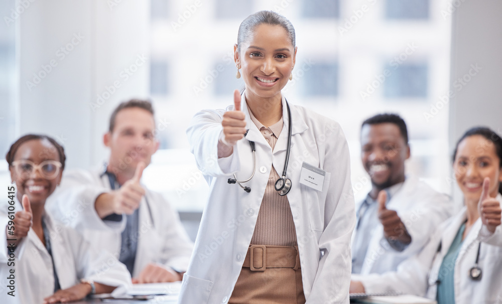My team is the A team. a female doctor giving the thumbs up during a staff meeting. My team is the A team. a female doctor giving the thumbs up during a staff meeting.
