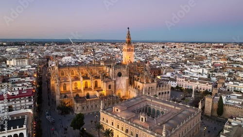 4k Aerial shot of Seville with gothic cathedral and famous Giralda bell tower. Seville, Spain. photo