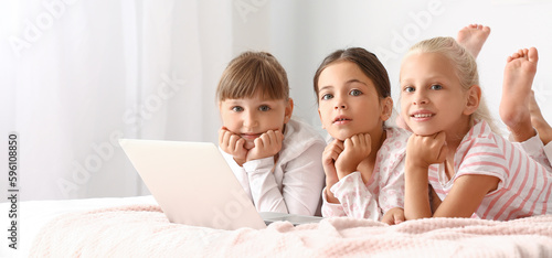 Cute little girls with lapt...