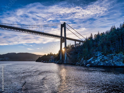 Sun is setting behind the Nordhordland Bridge during winter, Bergen, Norway