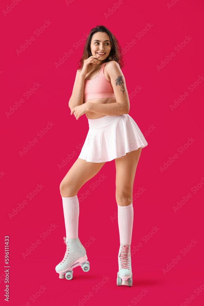 Young woman in roller skates on pink background Young woman in roller skates on pink background