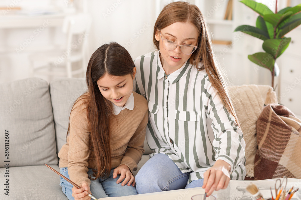 Drawing teacher giving private art lesson to little girl at home Drawing teacher giving private art lesson to little girl at home