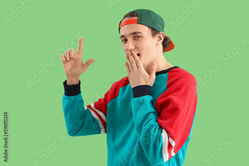Young man showing loser ges...
