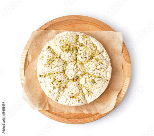 Plate of tasty Tahini halva with pistachios on white background photo