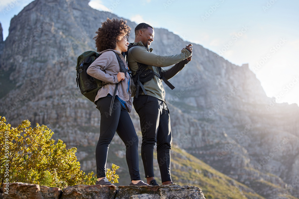 Thats an awesome shot. Full length shot of an affectionate young couple taking photos while out on an early morning hike.