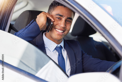 The master of multitasking. Cropped portrait of a handsome young businessman making a phonecall while driving himself to work. © Anela Ramba/peopleimages.com