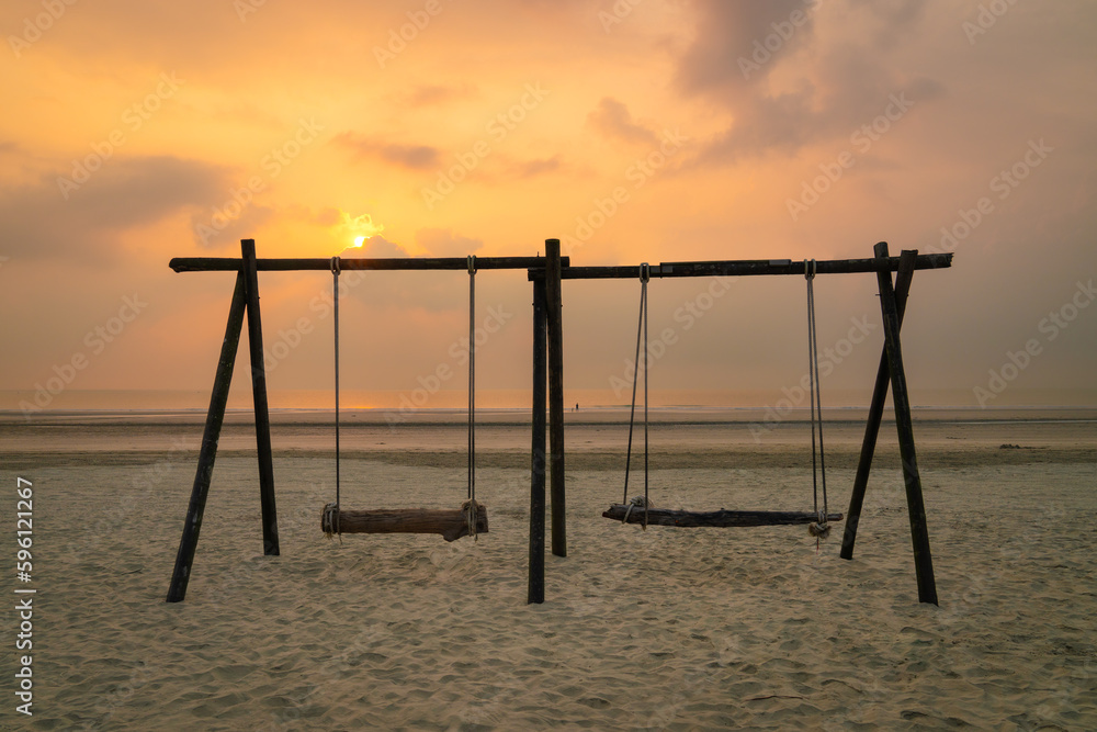 Beach landscape with swing set during sunrise. Travel vacation concept. Beach landscape with swing set during sunrise. Travel vacation concept.