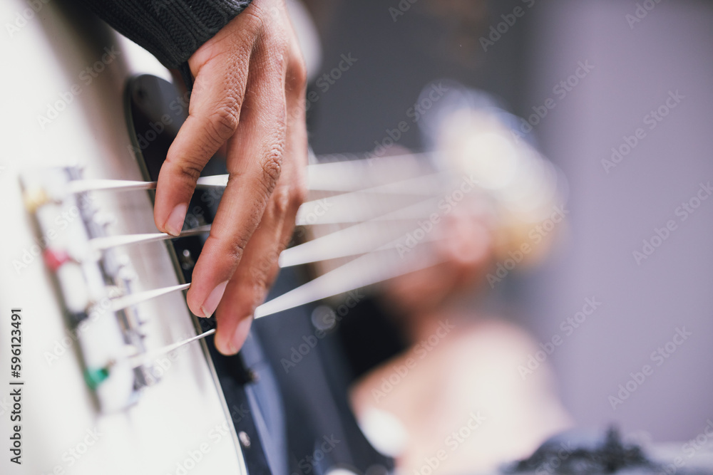 Living a life full of music. an unrecognisable man playing the guitar in a music studio during the day. Living a life full of music. an unrecognisable man playing the guitar in a music studio during the day.