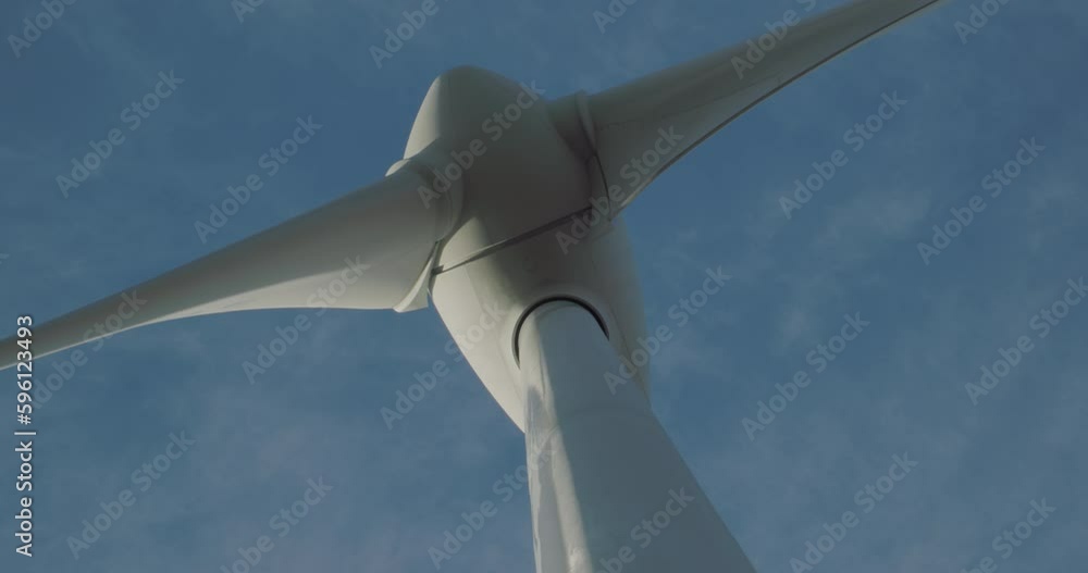 Close up of wind turbine windmill turning in a blue sky with clouds
Close up of wind turbine windmill turning in a blue sky with clouds