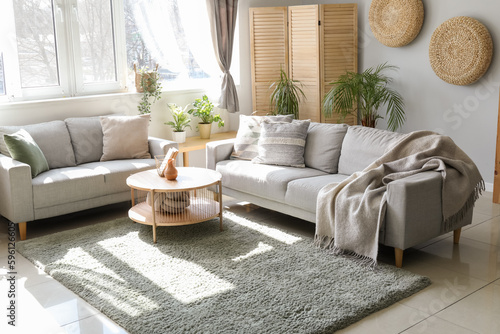 Schilderij op canvas Interior of light living room with sofas, houseplants and table