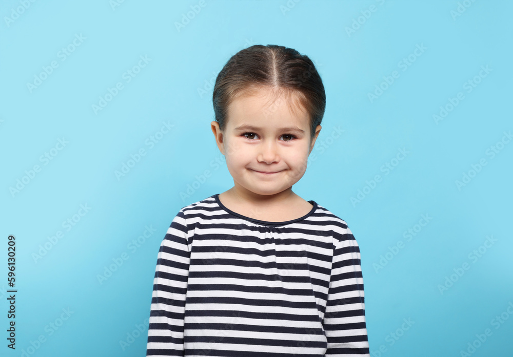 Beautiful happy girl on light blue background Beautiful happy girl on light blue background